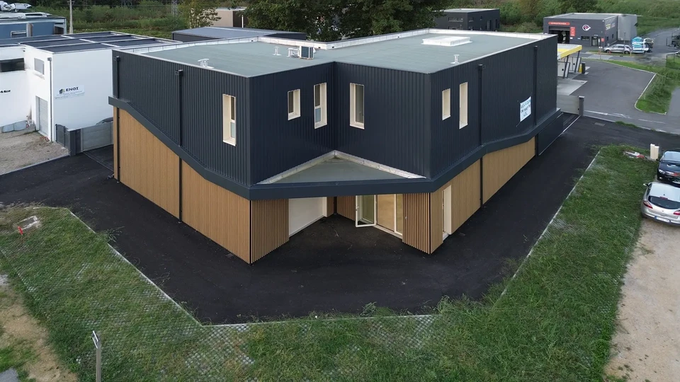 Gros plan sur des mains d'ouvriers installant des tuiles de toit en c&eacute;ramique jaune mont&eacute;es sur des planches en bois recouvrant un toit de b&acirc;timent r&eacute;sidentiel en construction